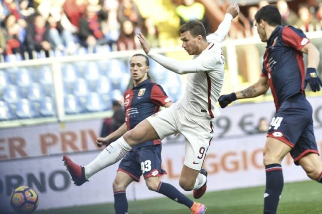 Roma's forward Edin Dzeko (C) kicks the ball during an Italian Serie A football match agai