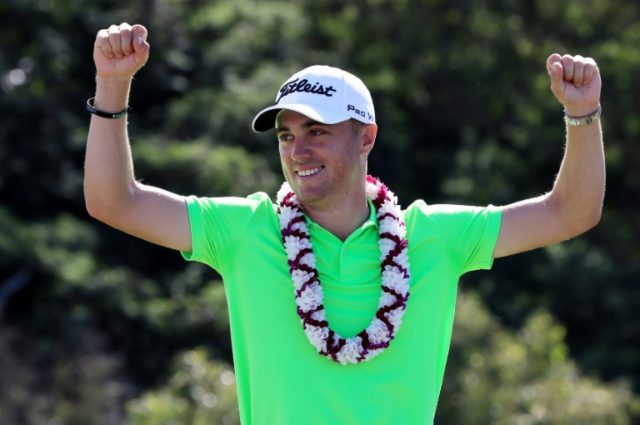 Justin Thomas of the United States celebrates on the 18th green after winning at Kapalua G