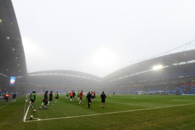 Players warm up in the mist for the English FA Cup third round football match between Bolt