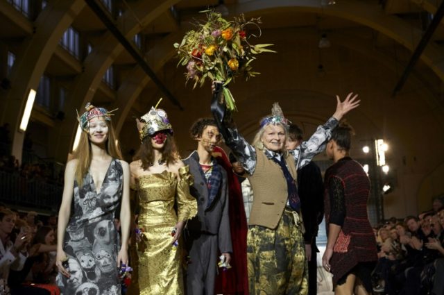 British fashion designer Vivienne Westwood (R) greets the audience following her show on t