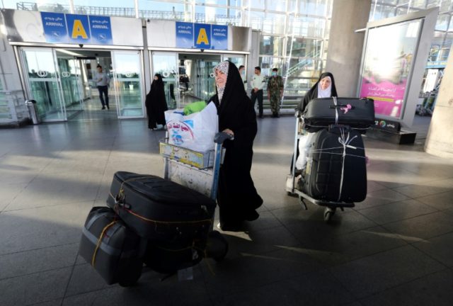 Iranian pilgrims arrive at the Imam Khomeini international airport in Tehran following the