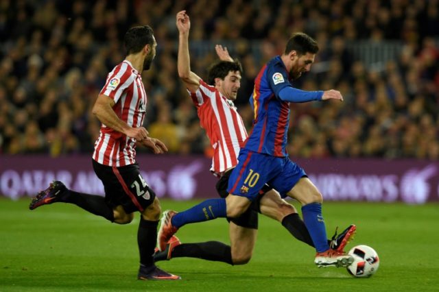 Barcelona's forward Lionel Messi (R) vies with Athletic Bilbao's defender Mikel San Jose (