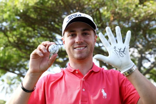 Justin Thomas of the United States celebrates after scoring a 59 during the first round of