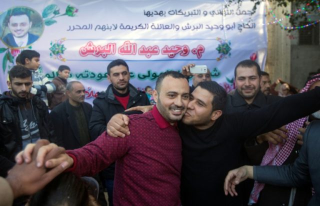 UN worker Waheed Borsh (centre) celebrates with his Palestinian relatives after he was rel