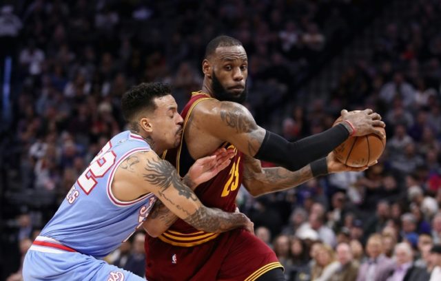 LeBron James of the Cleveland Cavaliers is guarded by Matt Barnes (L) of the Sacramento Ki