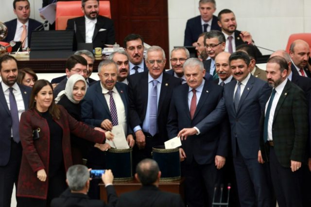 Turkish Prime Minister Binali Yildirim (3rd R) and lawmakers pose as they cast their ballo