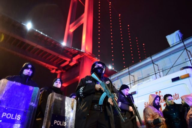 Turkish anti-riot police officers stand guard at the site of an armed attack at an Istanb