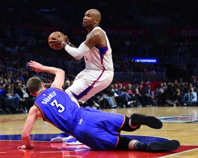 Marreese Speights of the Los Angeles Clippers dribbles past Domantas Sabonis of the Oklaho