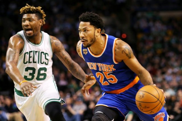 Derrick Rose (R) of the New York Knicks drives against Marcus Smart of the Boston Celtics