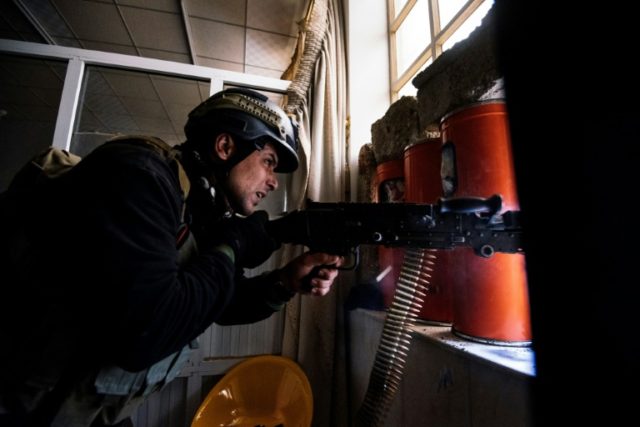 An Iraqi commando fires his machine gun during an offensive against Islamic State jihadist