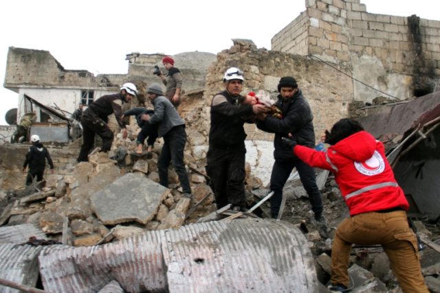 Syrian Civil Defence volunteers rescue children from a damaged building following a report