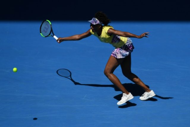 Venus Williams of the US hits a return against Switzerland's Stefanie Voegele during their