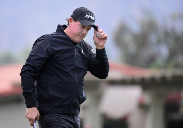 Phil Mickelson reacts to his par putt on the second hole during the first round of the Car