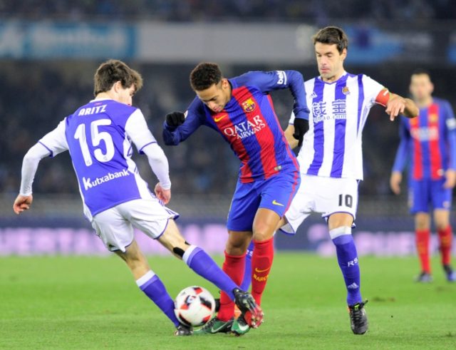 Barcelona's forward Neymar da Silva Santos Junior (C) vies with Real Sociedad's defender A
