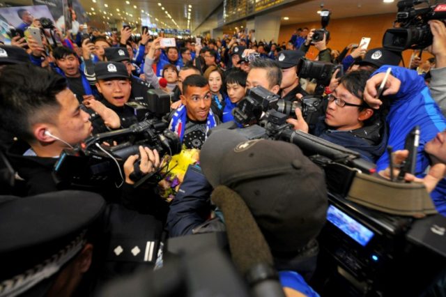 Argentine striker Carlos Tevez makes his way through the arrivals halls at Shanghai Pudong