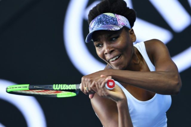 Venus Williams hits a return against Duan Ying-Ying of China during their Australian Open