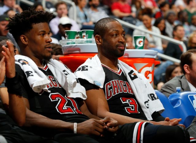 Jimmy Butler (L) and Dwyane Wade of the Chicago Bulls look on from the bench during the ga