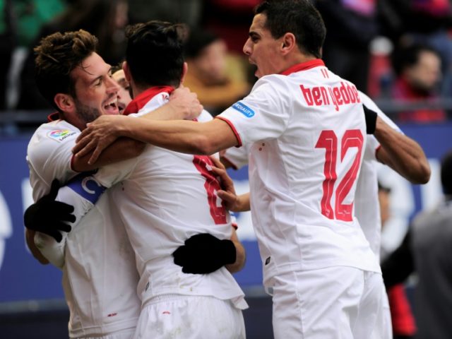 Sevilla players celebrate after their team scored the third goal during the Spanish league