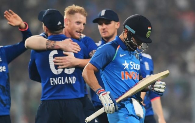 England's Ben Stokes (C) celebrates with teammates after taking the wicket of India captai