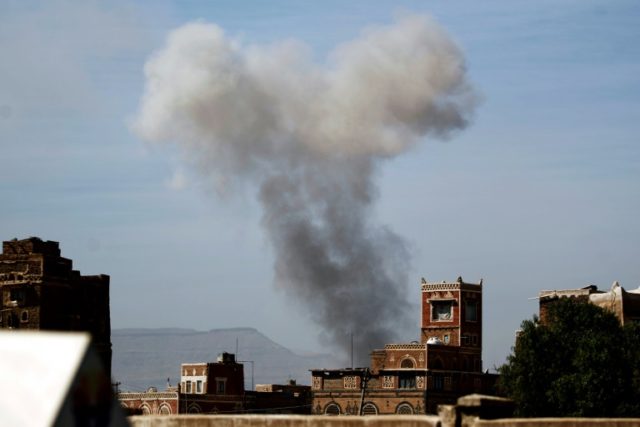 Smoke billows behind a building following a reported air strike by the Saudi-led coalition