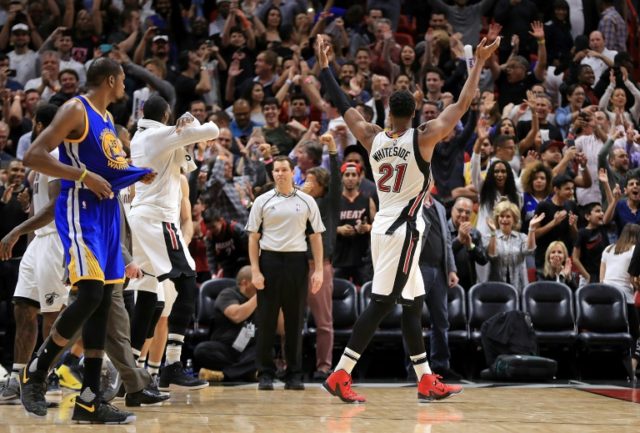 The Miami Heat players celebrate after winning their NBA game against the Golden State War
