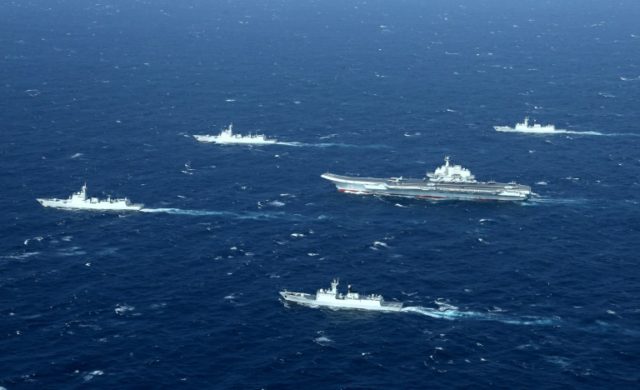 A Chinese navy formation, including the aircraft carrier Liaoning (C), during military dri
