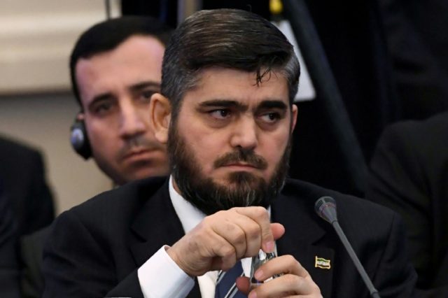 Chief rebel negotiator Mohammad Alloush attends the first session of Syria peace talks at
