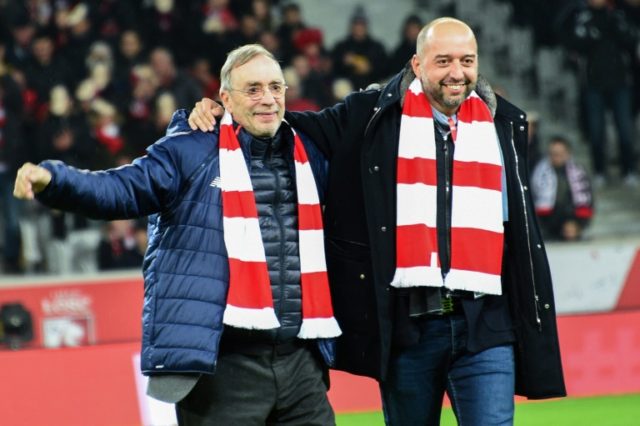 Lille's outgoing president Michel Seydoux (L) enters the field with new president Gerard L