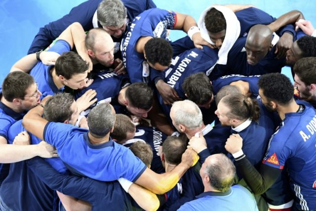 The French national handball team celebrate after winning their semi-final handball match