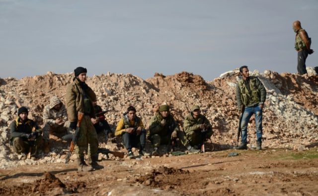 Fighters from the Free Syrian Army take a break during fighting against Islamic State (IS)