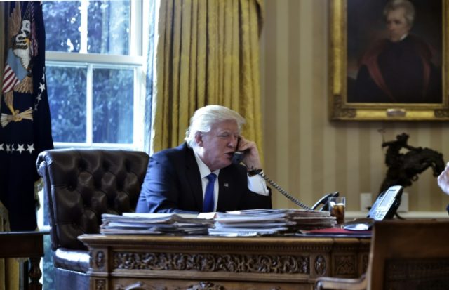 US President Donald Trump speaks on the phone with Russia's President Vladimir Putin from the Oval Office of the White House on January 28, 2017