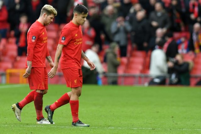 Liverpool's Alberto Moreno (L) and Philippe Coutinho leave the pitch following their Engli