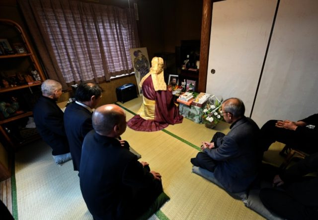Buddhist monk Kaichi Watanabe chants sutras to commemorate the one-year anniversary of a w
