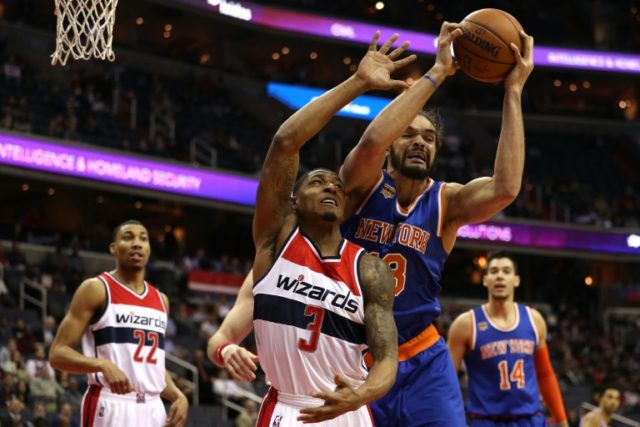 Joakim Noah of the New York Knicks and Bradley Beal of the Washington Wizards battle for a