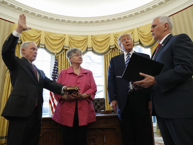 President Donald Trump watches as Vice President Mike Pence administers the oath of office