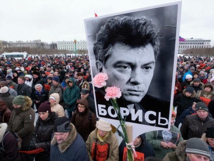 FILE - In this Sunday, Feb. 26, 2017 file photo, People gather in memory of opposition leader Boris Nemtsov, portrait in center, in St. Petersburg, Russia. Russia's opposition movement struggles to rally around one unifying figure two years after Nemtsov, a former deputy prime minister, was gunned down just outside …