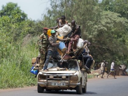 People stand on a car with their belongings on the road from Mbaiki to Bangui on April 8, 2014. The crisis in the strife-torn Central African Republic has left 1.6 million people -- a third of the population -- in urgent need of food, the United Nations said Monday. Thousands …