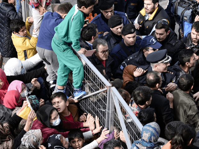 Migrants block the entrance of the Hellinikon camp in Athens in protest at poor living con