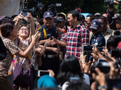 JAKARTA, INDONESIA - FEBRUARY 15: Basuki Tjahaja Purnama greets voters during his arrival on February 15, 2017 in Jakarta, Indonesia. Residents of Indonesia's capital went to the polls on Wednesday to vote for its new governor during an election marked by mass demonstrations against the incumbent governor Basuki Purnama Tjahaja, …