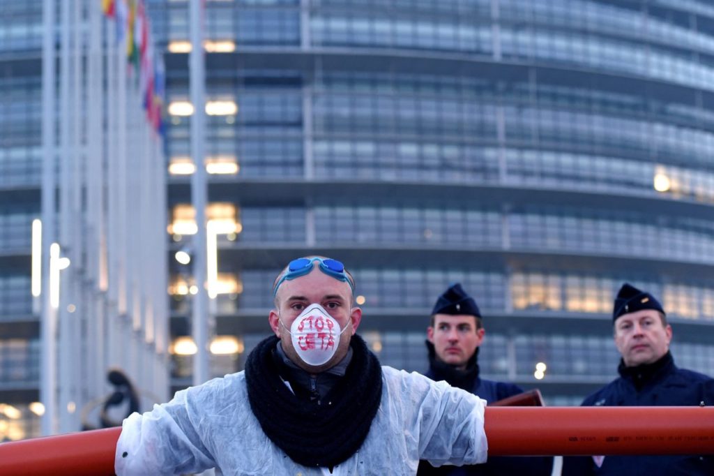 A protestors wearing a mask with the lettering 'Stop CETA' during a demonstration against the Transatlantic Trade and Investment Partnership (TTIP) and EU-Canada Comprehensive Economic and Trade Agreement (CETA) in front of the European Parliament in Strasbourg, eastern France, on February 15, 2017. / AFP / FREDERICK FLORIN (Photo credit should read FREDERICK FLORIN/AFP/Getty Images)
