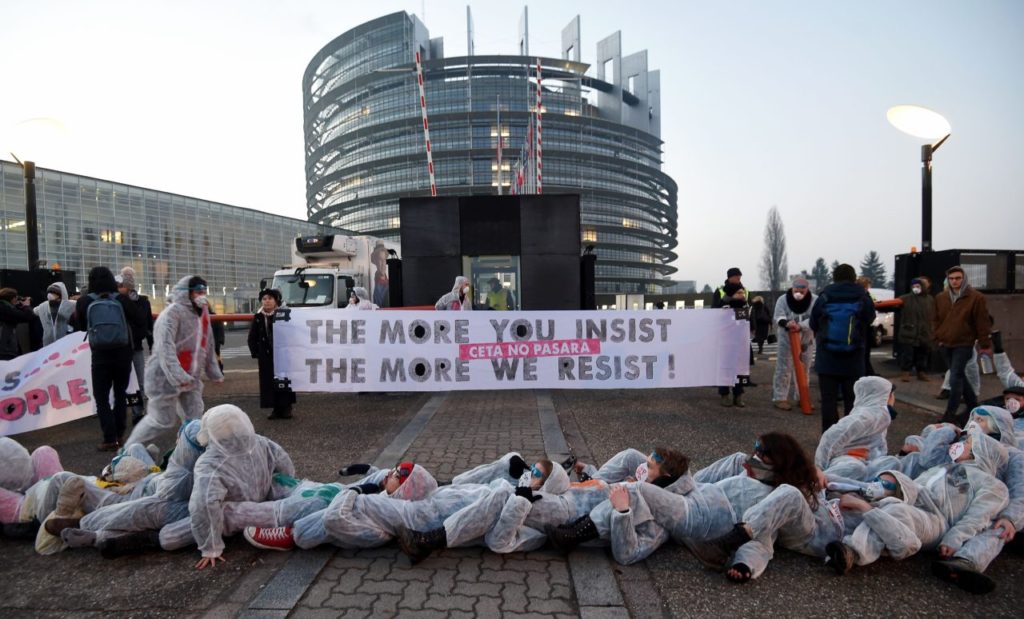 Protestors demonstrate against the Transatlantic Trade and Investment Partnership (TTIP) and EU-Canada Comprehensive Economic and Trade Agreement (CETA) with a banner reading 'The more you insist, the more we resist' in front of the European Parliament in Strasbourg, eastern France, on February 15, 2017. / AFP / FREDERICK FLORIN (Photo credit should read FREDERICK FLORIN/AFP/Getty Images)