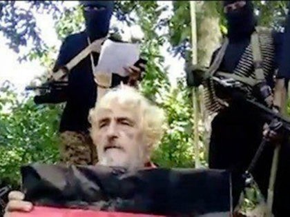 German hostage Jurgen Gustav Kantner kneels before his Islamic militant captors at an undisclosed location. (SITE Intel Group via AP)