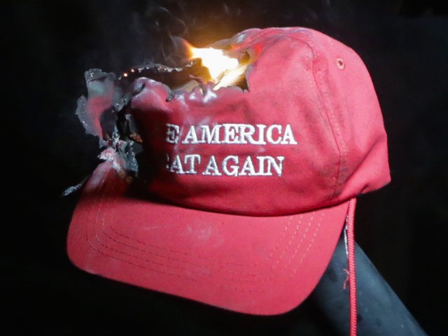 MAGA Make America Great Again hat burning at Berkeley (Elijah Nouvelage / Getty)