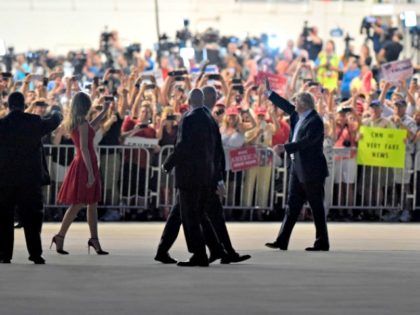 President Donald Trump, second from right, and first lady Melania Trump, third from left, wave to the crowd following the "Make America Great Again Rally" at Orlando-Melbourne International Airport in Melbourne, Fla., Saturday, Feb. 18, 2017. (AP Photo/Susan Walsh)