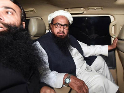 Pakistani leader of the Jamaat-ud-Dawa (JuD) organisation Hafiz Saeed (R) leaves in a car after being detained by police in Lahore, early on January 31, 2017. Pakistan has ordered the detention of the firebrand cleric linked to the 2008 Mumbai attacks which killed 166 people, according to a government directive …