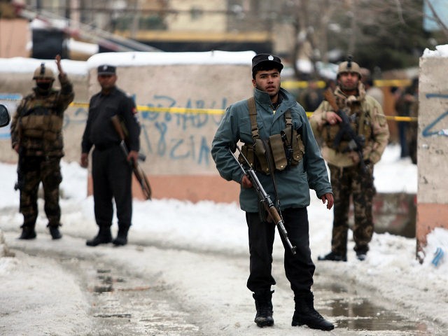 Security personnel stand guard at the site of a suicide attack on the Supreme Court in Kab
