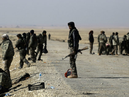 Fighters from the Syrian Democratic Forces gather near a village north-east of Raqa on Feb