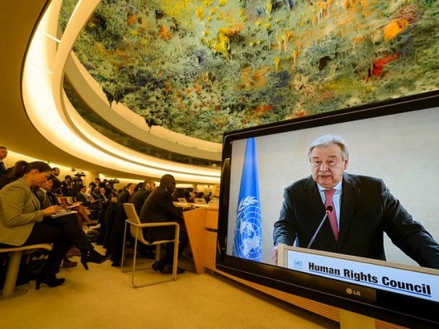 U.N. Secretary-General Antonio Guterres is seen on a TV screen while addressing the United
