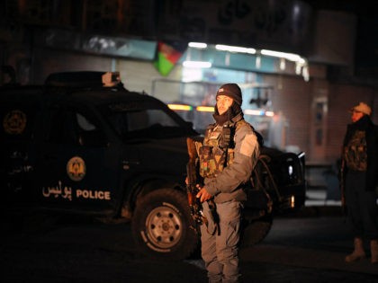 This picture taken on January 10, 2017 shows Afghan policemen standing guard at the site o