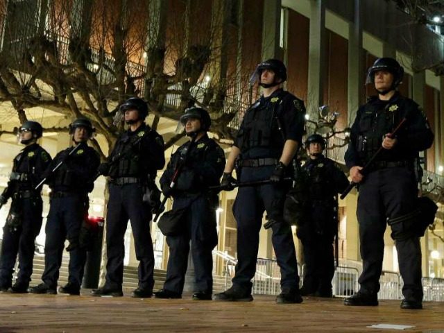 University of California at Berkeley police guard the building where Breitbart News editor